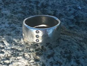 We found Kelly's silver diamond ring in the deep grass